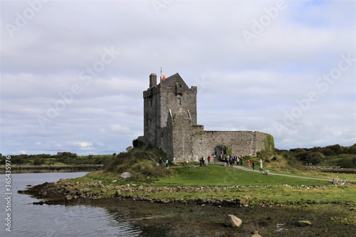 Dunguaire tower house with defensive wall on the south eastern shore of the bay in County Galway  Ireland.