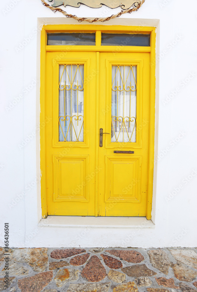 traditional wooden yellow door at Koufonisia islands Cyclades Greece
