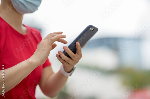 Asian woman using smartphone in modern city