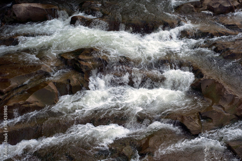 Close up waterfall. Cascading water falling over the rocks.