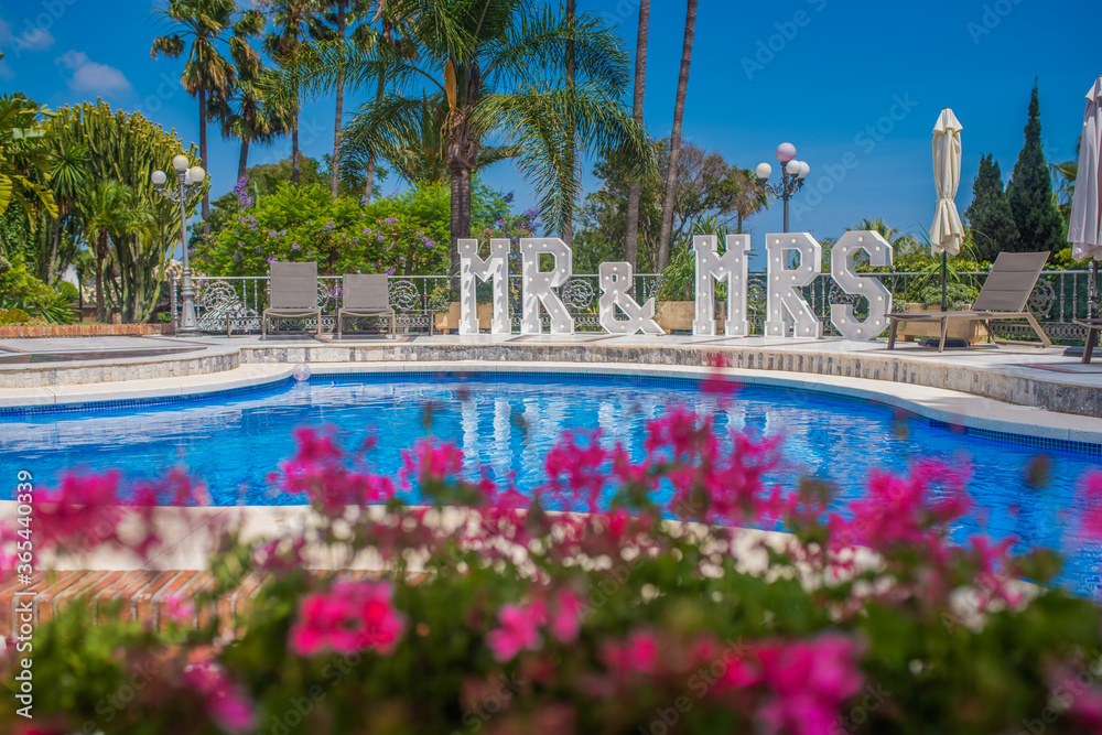 floral wedding venue in spain costa del sol with mr and mrs huge letters and swimming pool