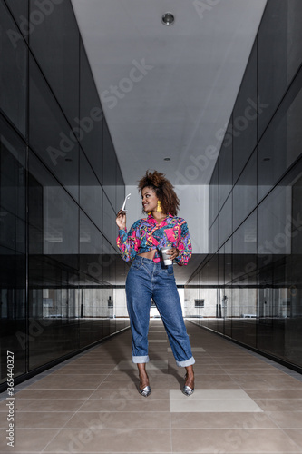 Fashionable African American woman with cup of coffee to go