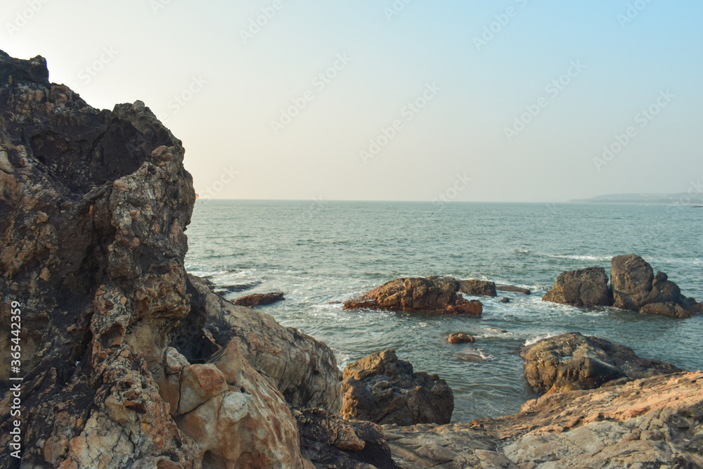 Fototapeta premium beautiful sunset on the beachside over the side rock