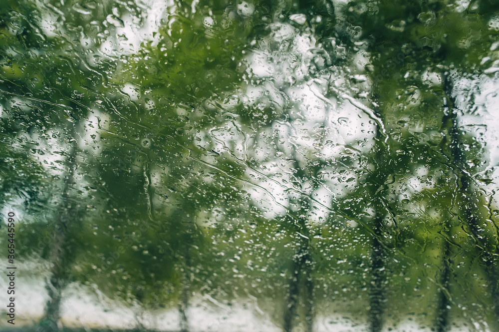 Raindrops on the window glass. Looking out through the window.