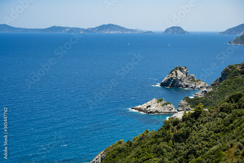 View from the coast to the church of Agios Ioannis on the Mamma Mia Cliff on the island of Skopelos, surrounded by the blue Mediterranean sea.