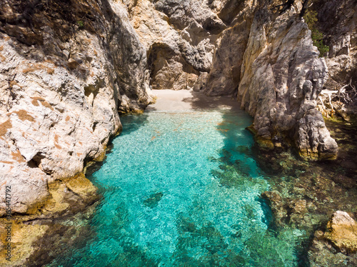 Clear turquoise sea water in the Amarandos Cove on the island of Skopelos is a reminder of a refreshing holiday in the Mediterranean summer.
