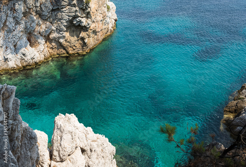 The summer sun invites the clear clean blue and turquoise water to shine in a bay of Skopelos Island and you want to jump in for refreshment. photo