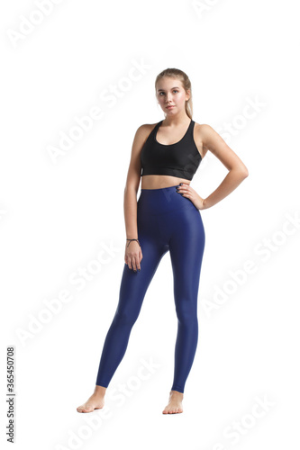 Young slim girl in sportswear isolated on white background.