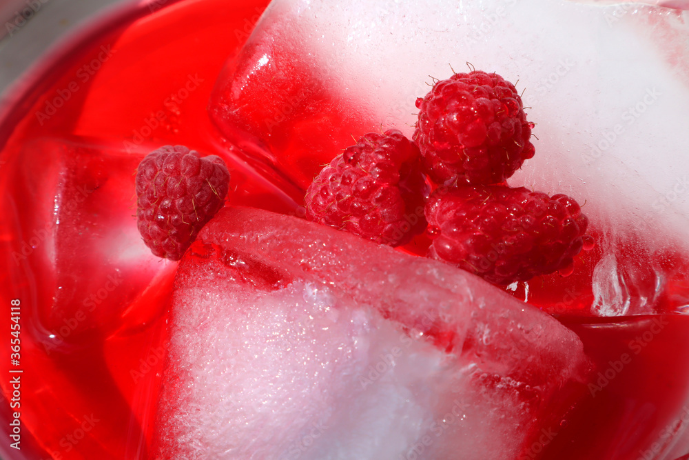 Raspberry juice with ice in a glass Raspberry juice with ice in a glass
