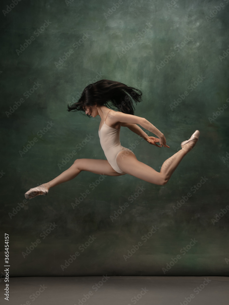 Target, achievement. Graceful classic ballerina dancing on dark studio background. Pastel bodysuit. The grace, artist, movement, action and motion concept. Looks weightless, flexible. Fashion, style.