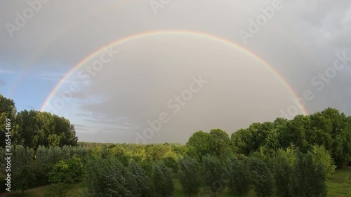180 degrees original rainbow arch / blue sky and clouds  timelapse