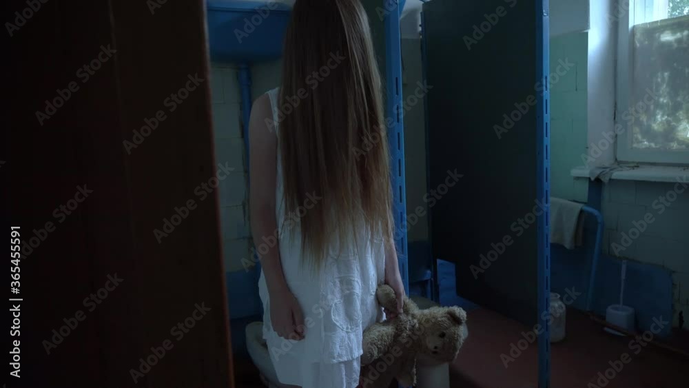 in the old school, in a room in the toilet, a girl in a white dress with long hair on her face. in his hand, he has a Teddy bear, the interior of an abandoned house, post-apocalyptic ruins. in the old school, in a room in the toilet, a girl in a white dress with long hair on her face. in his hand, he has a Teddy bear, the interior of an abandoned house, post-apocalyptic ruins.