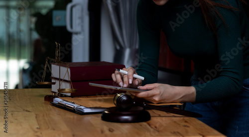Concepts of Law and Legal services. lawyer businesswoman working on digital tablet in office. © SOMKID