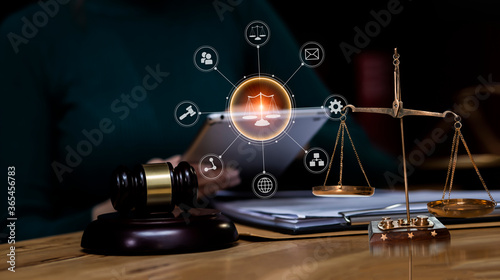 Concepts of Law and Legal services. lawyer business working on digital tablet and law interface icons.