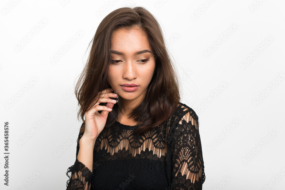 Studio shot of young beautiful Asian woman