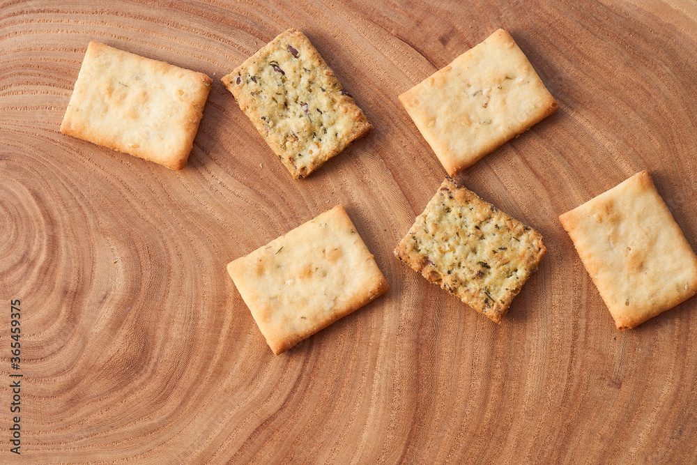 Wheat dry biscuits with spices on a wooden table