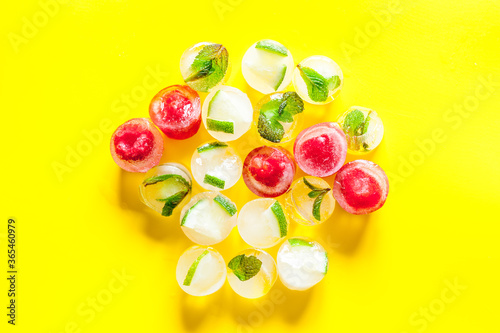 Berries and mint in ice cubes top view copy space