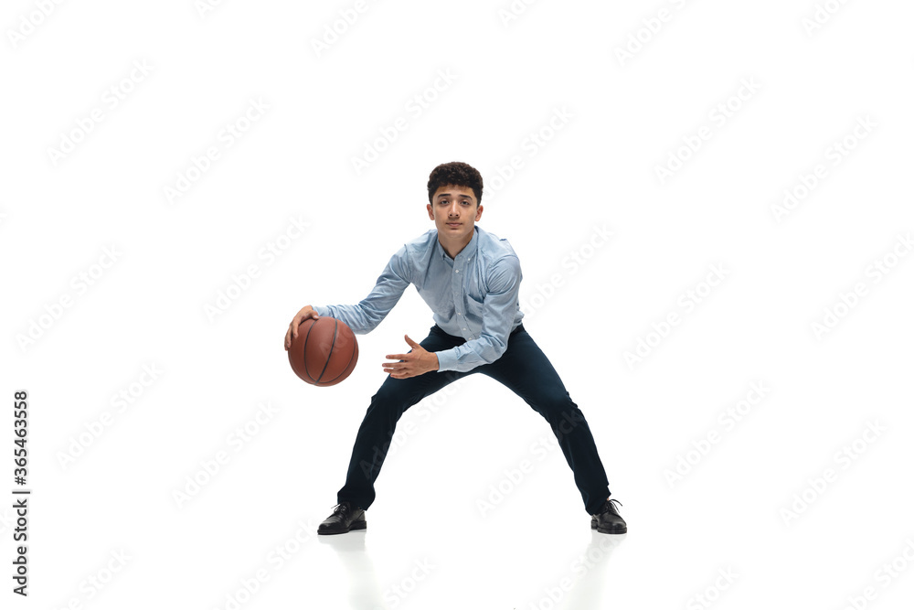Boss. Man in office clothes playing basketball on white background like professional player, sportsman. Unusual look for businessman in motion, action with ball. Sport, healthy lifestyle, creativity.