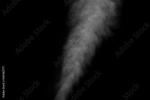 Abstract steam with dots of spray moves on a black background. Figured smoke can be used for design