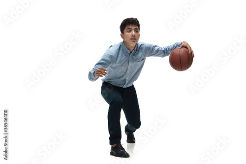 Boss. Man in office clothes playing basketball on white background like professional player, sportsman. Unusual look for businessman in motion, action with ball. Sport, healthy lifestyle, creativity.