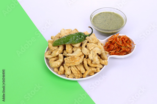 Indian Traditional Spicy food Gathiya, Gathiya Namkeen with green chili and beat salad. Popular tea time snack in Gujarat photo