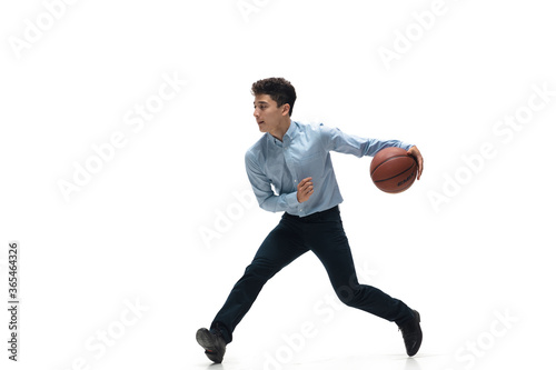 Boss. Man in office clothes playing basketball on white background like professional player, sportsman. Unusual look for businessman in motion, action with ball. Sport, healthy lifestyle, creativity.