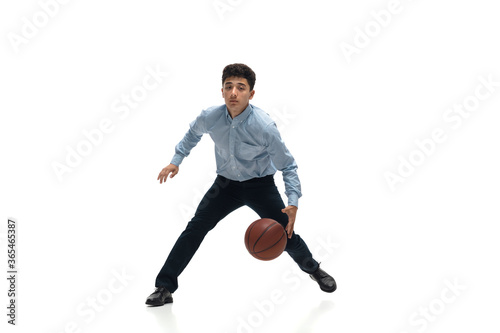Boss. Man in office clothes playing basketball on white background like professional player, sportsman. Unusual look for businessman in motion, action with ball. Sport, healthy lifestyle, creativity.
