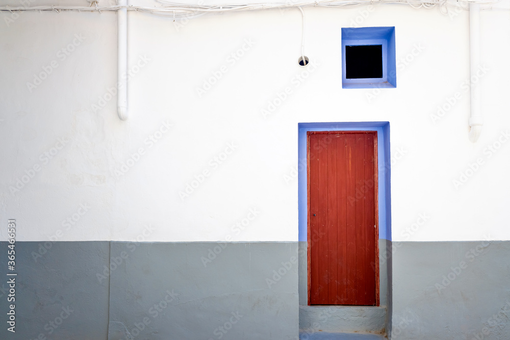 Wall and door of a rural house in a small Mediterranean town.