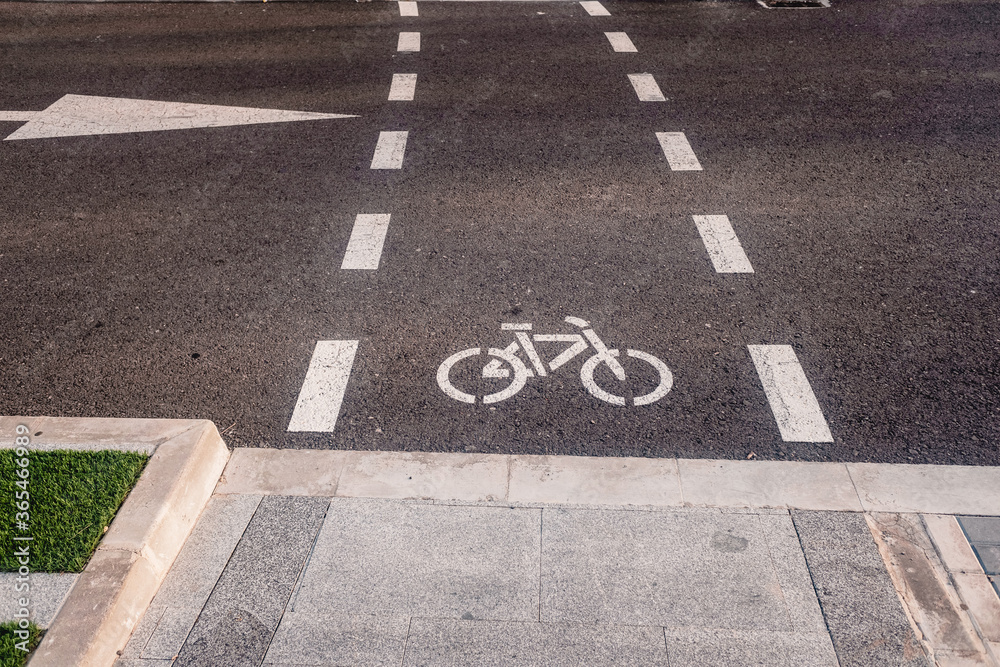Fototapeta premium New bike lanes next to recharging stations for electric vehicles on paved asphalt.