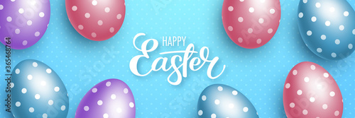 Realistic polka dot eggs on light blue background. Easter greeting card or invitation template