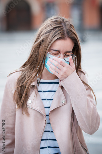 Young woman wearing medical face mask to protect herself and others
