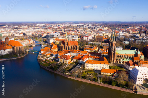 Scenic view from drone of Gothic buildings of Cathedral of St. John Baptist and Collegiate Church of Holy Cross and St. Bartholomew on Ostrow Tumski on sunny day, Wroclaw, Poland..