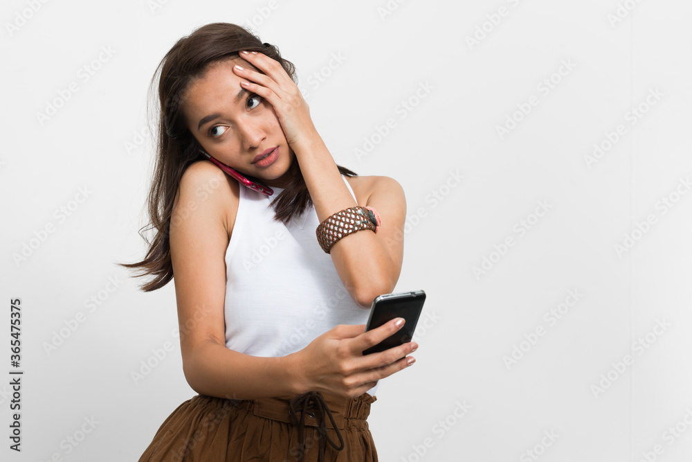 Naklejka premium Studio shot of young beautiful Asian woman