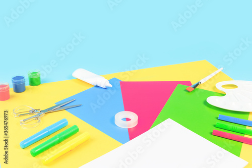 Female doctors hand in blue protective glove holding a stethoscope, tablets or pills mockup jars. White desk. Virus protection. Medicine and healthcare. Medical concept monochrome banner copy space