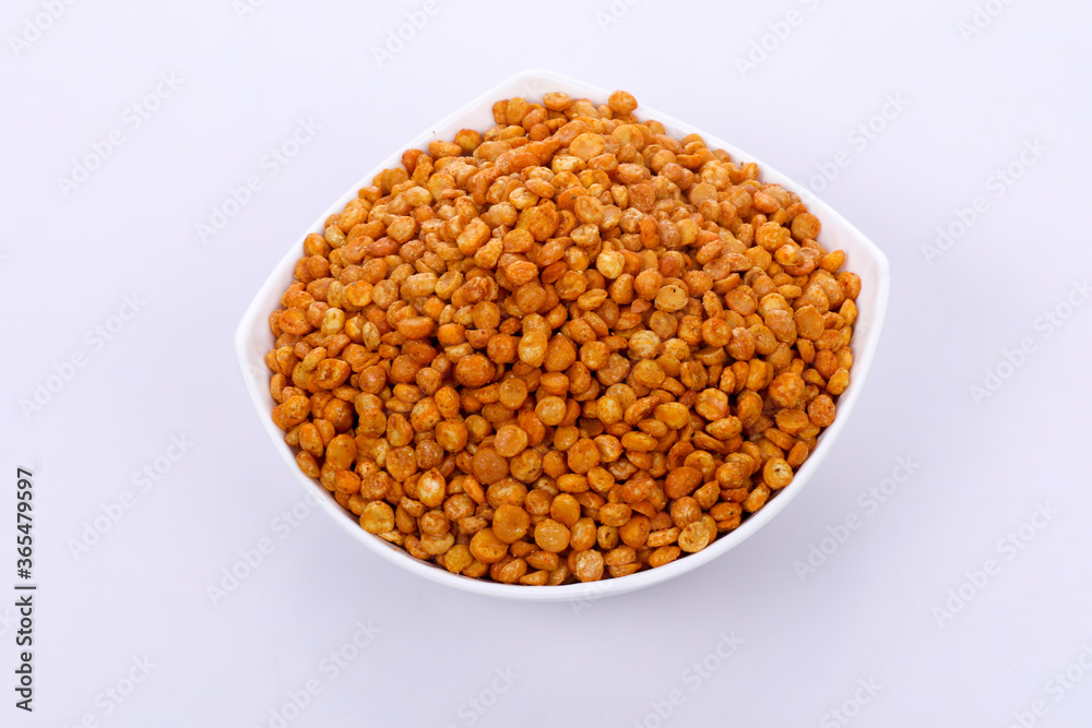 Fried Salted Chana Dal Masala in white bowl on dark background. Chana Dal is a very popular Gujarati snack.
Fried Salted Chana Dal Masala in white bowl on dark background. Chana Dal is a very popular Gujarati snack.