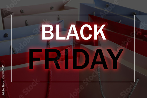 Colorful shopping bags as background, closeup. Black Friday Sale