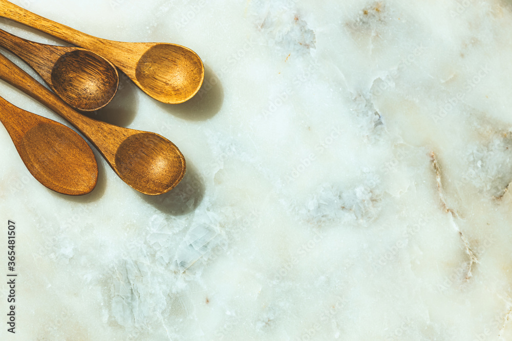 four wooden spoons on marble texture four wooden spoons on marble texture