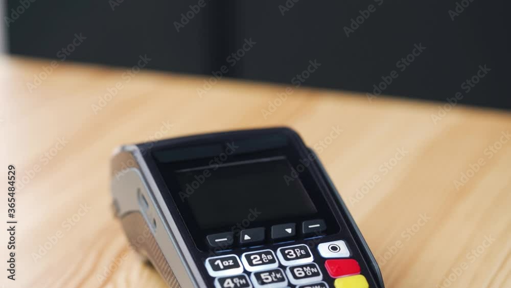 Contactless payment with your smartphone with green mock-up screen. Wireless payment concept. Close-up, woman using smartphone cashless wallet NFC technology to pay order on bank terminal. Contactless payment with your smartphone with green mock-up screen. Wireless payment concept. Close-up, woman using smartphone cashless wallet NFC technology to pay order on bank terminal.