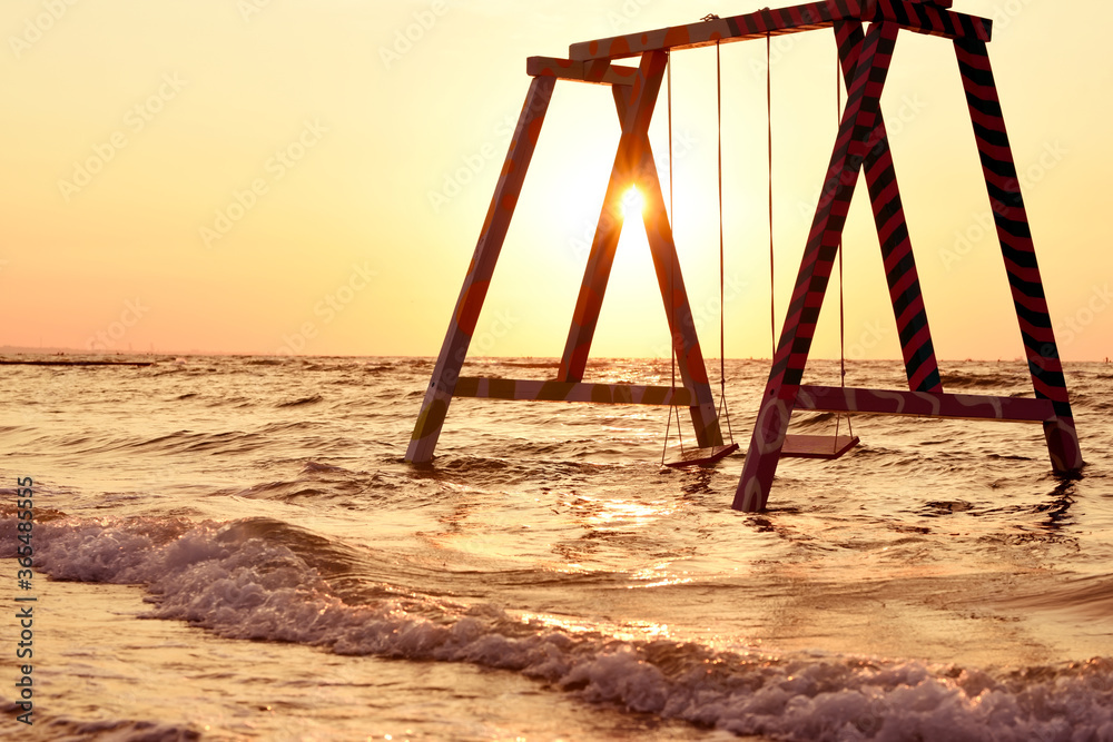 Swing in the sea on a deserted beach at dawn.
Swing in the sea on a deserted beach at dawn.