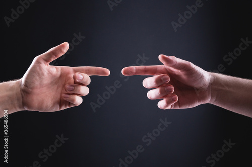 Two men s hands point at each other with index fingers. The concept of mutual understanding between men expressed in hand gestures