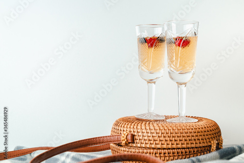 Vintage Wineglass with wine and berries top view isolate on white background.
Summer cool drinks. space for text. 
Wineglass are on  wicker bag. Summer mood