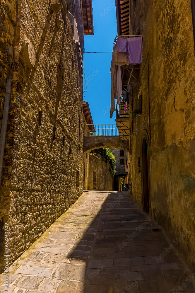A view up a side street in the cathedral city of Gubbio, Italy in summer