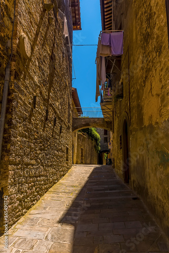 A view up a side street in the cathedral city of Gubbio, Italy in summer
