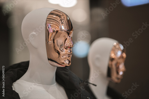 Close-up mannequin face with reflective mirror surface photo