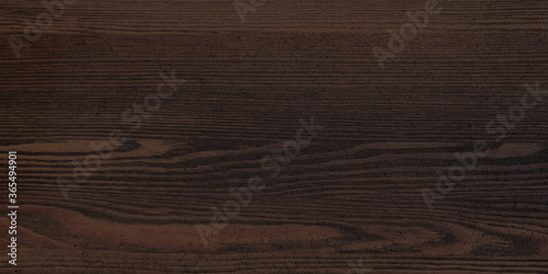 Texture of black and dark brown old wood. Old board with knots. Wide burned board texture close-up  panoramic banner.