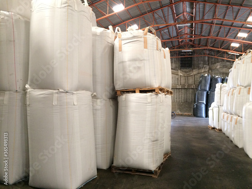 White hemp sacks containing chemical fertilizer Large  sidebar placed on wooden pallets. To wait for delivery to customers