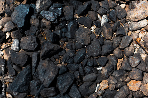 Natural abstract textured background of black stones.