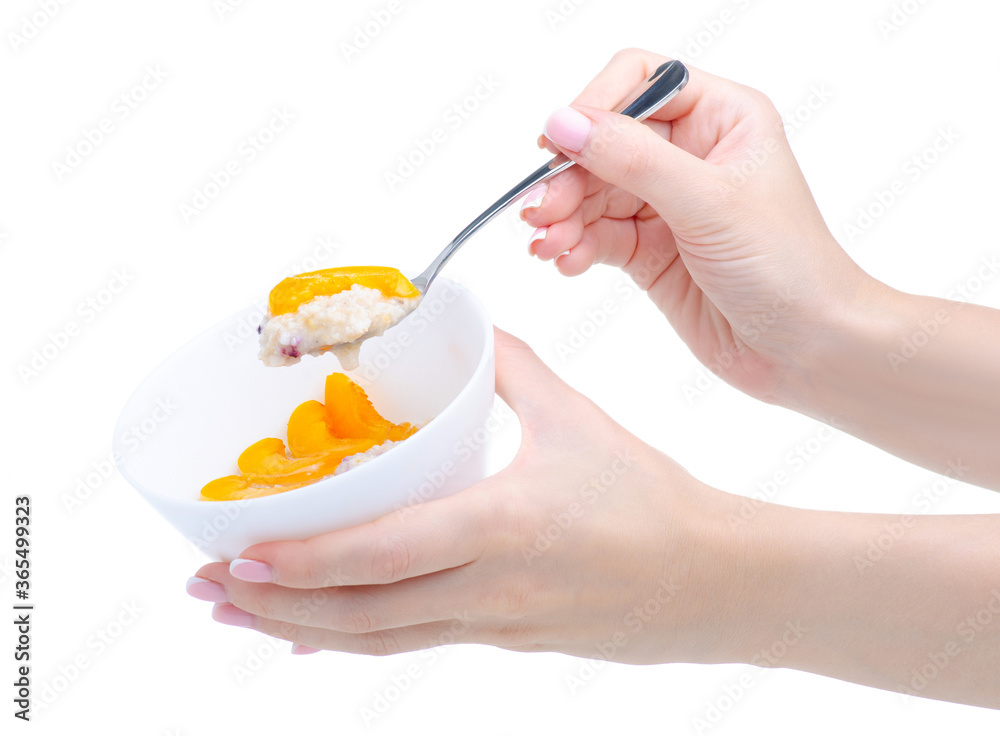 Hand holding bowl oatmeal with fruit, spoon on white background isolation Hand holding bowl oatmeal with fruit, spoon on white background isolation