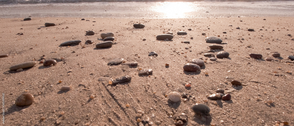 Smooth pebbles on sandy beach. Low angle. Smooth pebbles on sandy beach. Low angle.