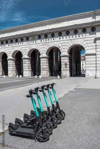 Photography Rental Electric Scooters, e-scooter, Parked In Group In Front Of Historic Buildi